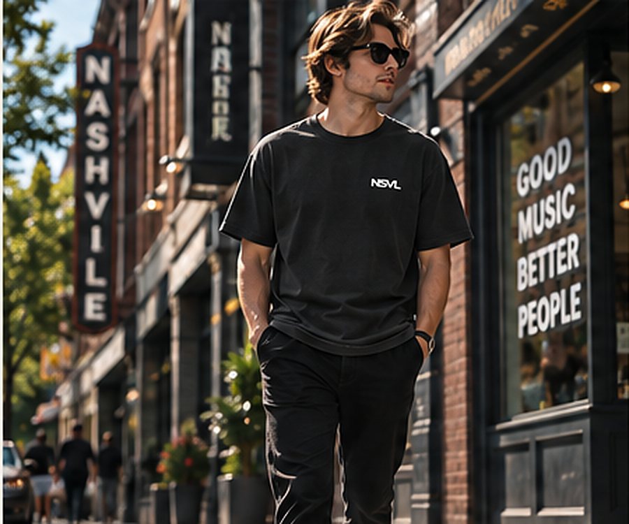 Illustration: a person in a charcoal NSVL tee walking past brick storefronts.