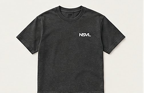 Illustration: heavyweight charcoal tee with a small paper-white NSVL mark.