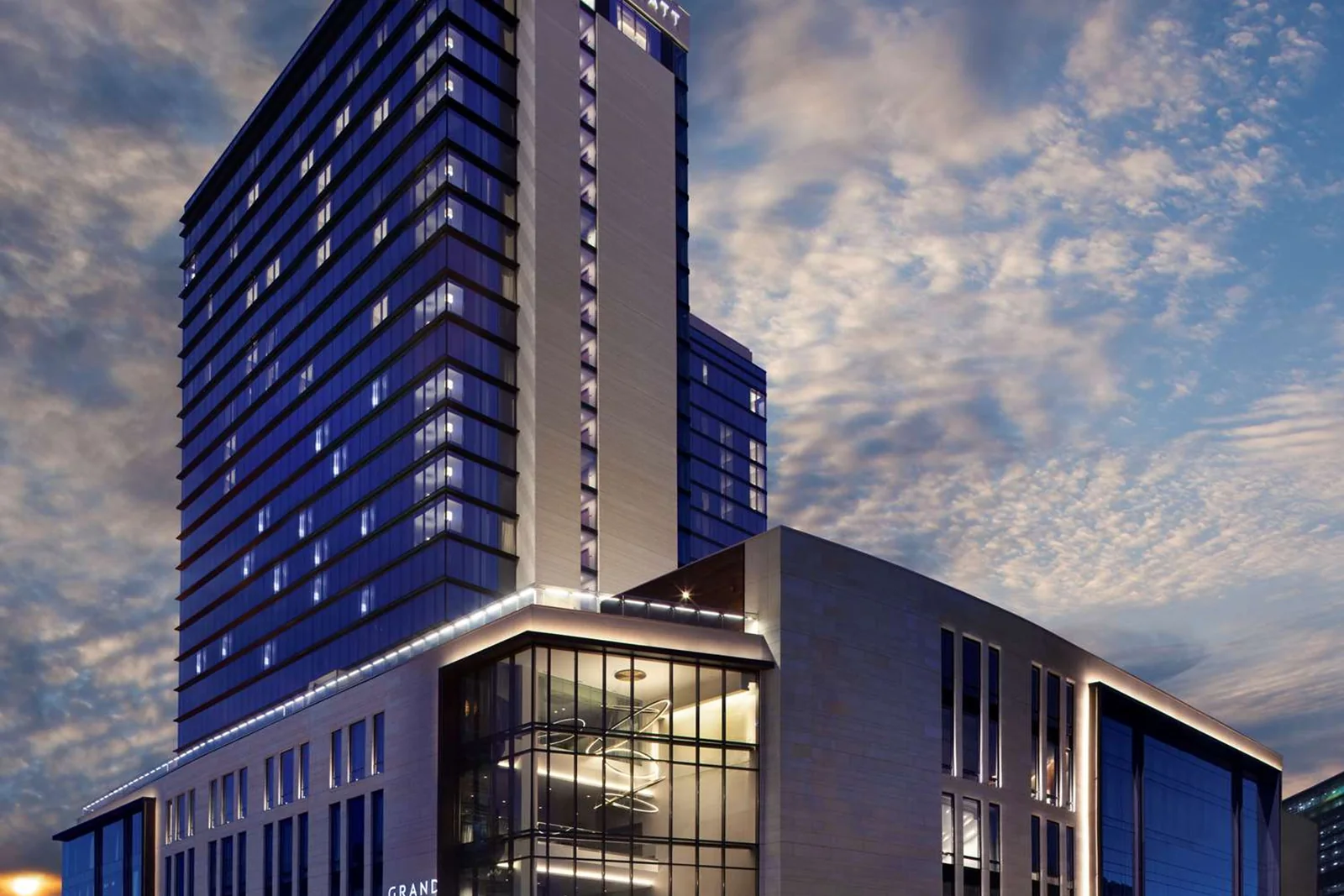 Grand Hyatt Nashville and surrounding Nashville Yards mixed-use buildings at dusk.