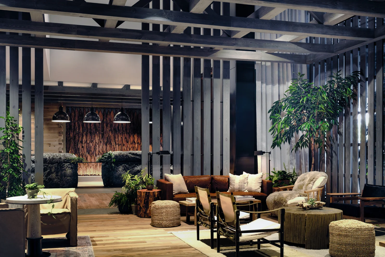 1 Hotel Nashville lobby with timber structure, leather seating, and abundant greenery.