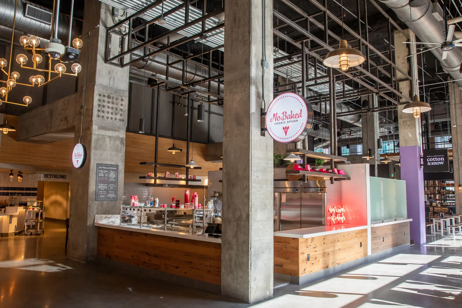 Interior of Assembly Food Hall with multiple vendor counters and open circulation.